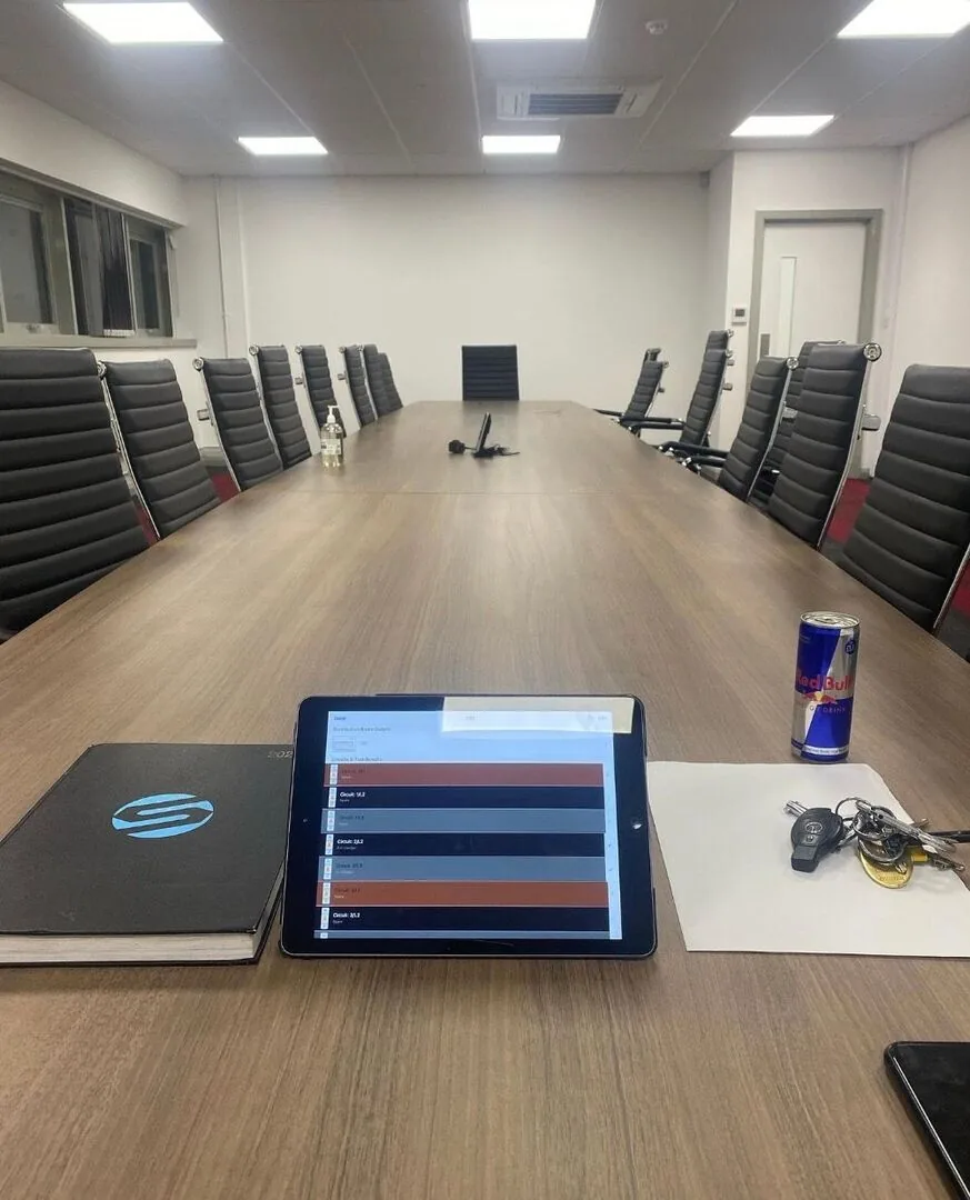Commercial office lit by LED panels with circuit test results on a tablet during an inspection by SEE Electrical
