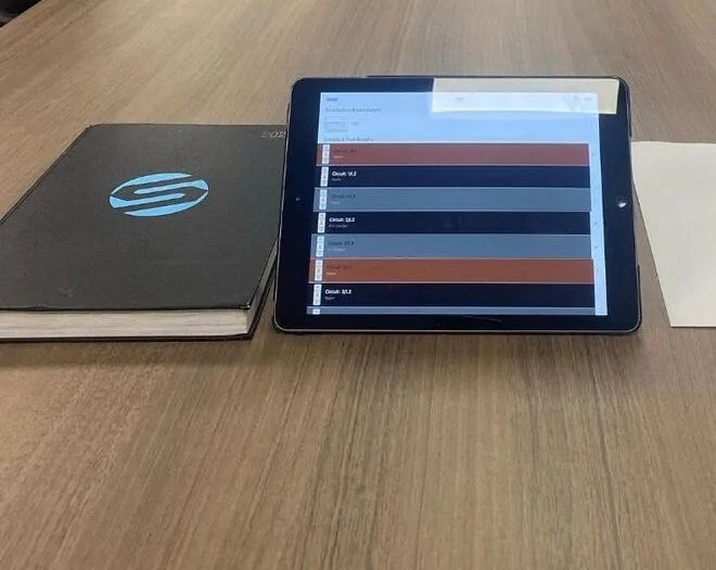 Circuit test results on a tablet on the boardroom table, recorded on site during the inspection